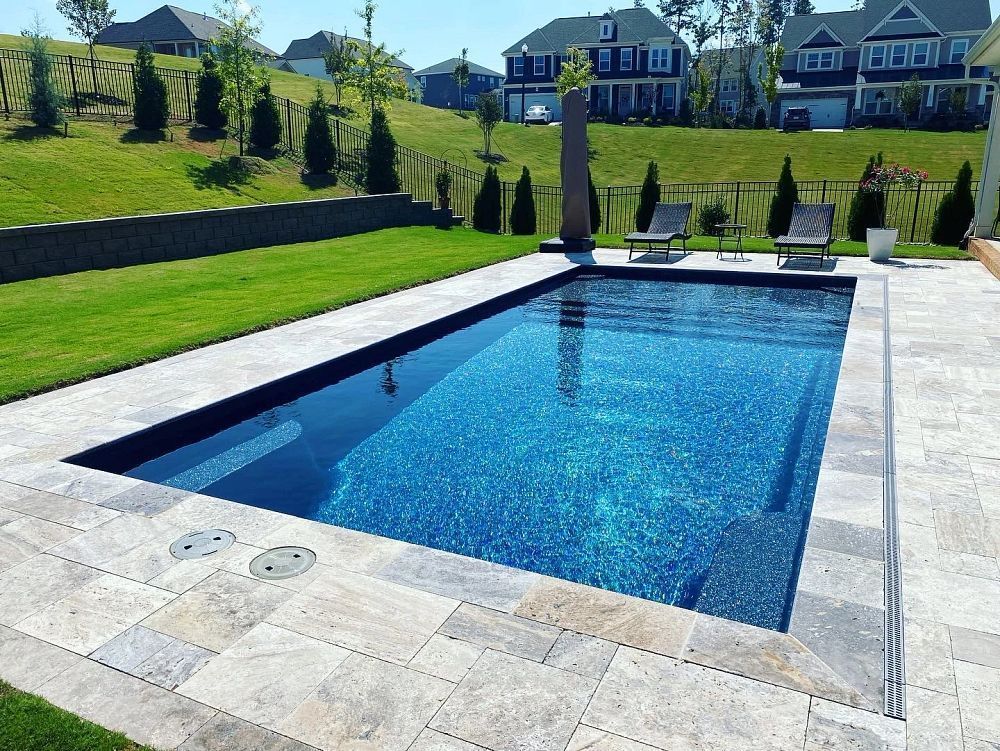 A clean backyard pool maintained by Bishop Pool Service and Repair